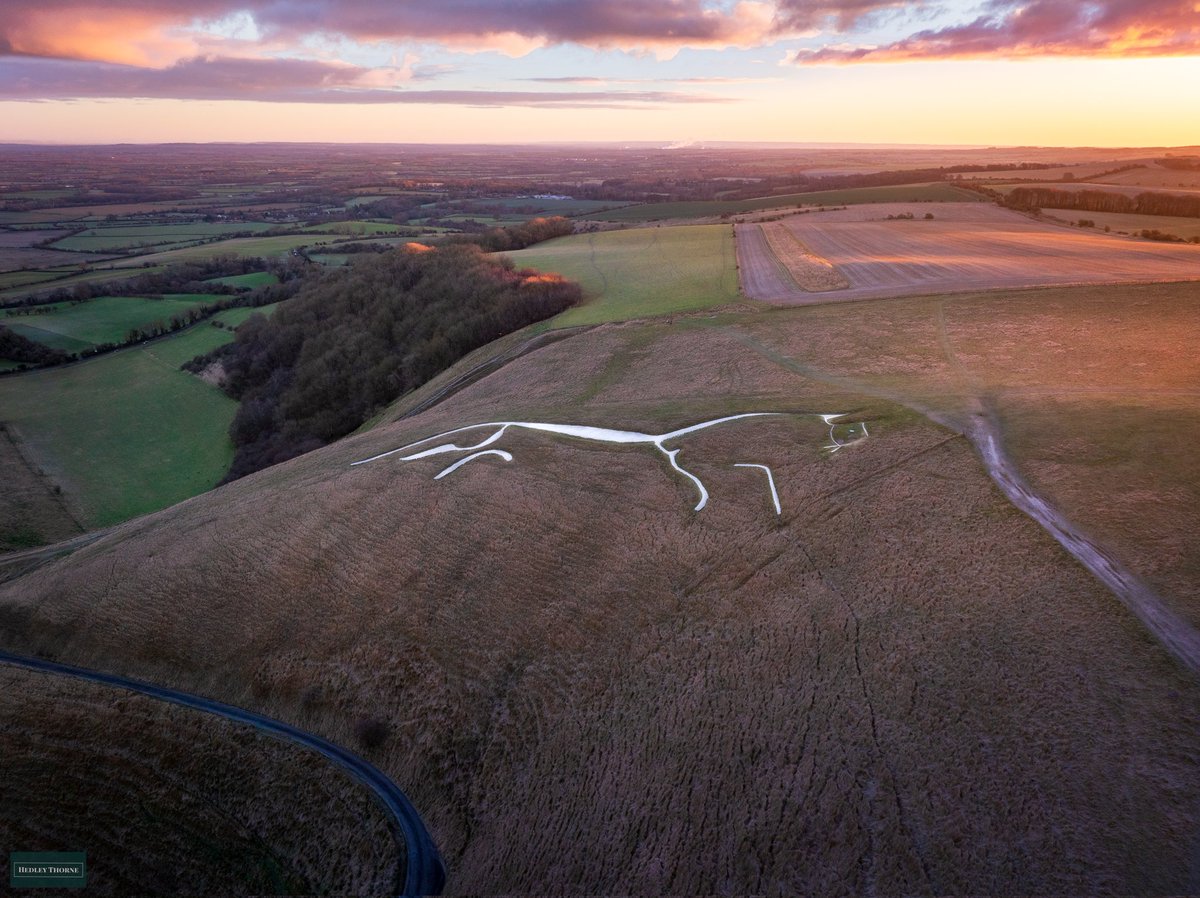 The Uffington White Horse at sunrise, still looking ice white from its last scouring. (For a full resolution download please buy me a coffee!) buymeacoffee.com/hedleythorne