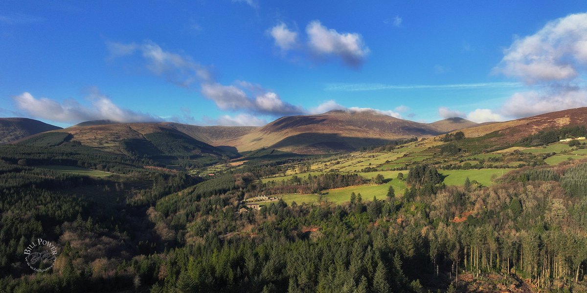 brigobhann's tweet photo. A beautiful Scottish-baronial house stood in the centre of this photo of Galtee Castle Wood and Galtymore Mountain. It was demolished in 1940 for no good reason. The stones were used to build Glanworth Catholic Church. #galtee #irishmountains @GlanworthG https://t.co/r2YTQBEqDl