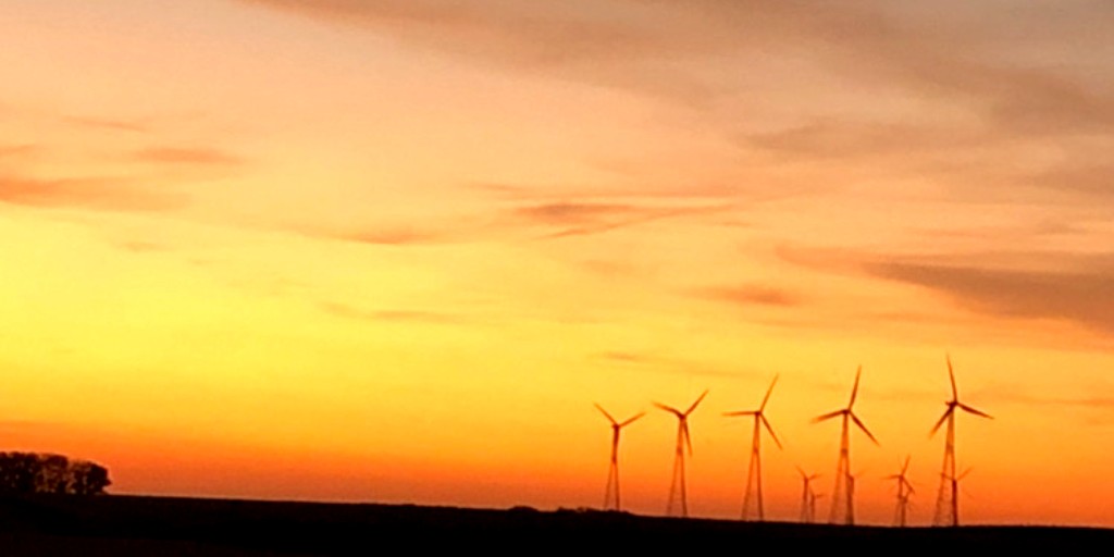 Storm Lake's wind turbines glow in the northwestern Iowa horizon. ALLETE Clean Energy purchased Storm Lake I & II ten years ago, and they can power nearly 50,000 homes.
