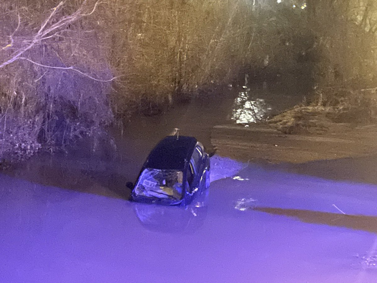 JoeBrunoWSOC9's tweet photo. The car is still in the water. It floated a little down the creek @wsoctv https://t.co/wjGHLwpyPo
