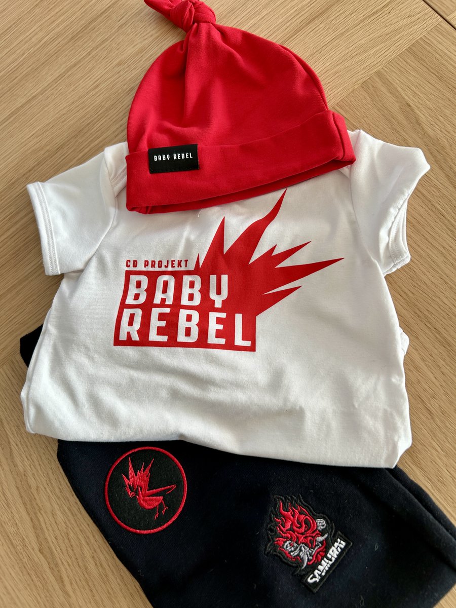 BartPyrko's tweet photo. Do you know what's great about @cdprojektred? Initiatives like this. 😍

Thank you @cdprojektred for these awesome gifts for new parents! ❤️❤️❤️

We're going to totally rebel with this baby! 😆
#REDS, Baby rebel designer is coming! 💪😀

#dadcontent #babyrebel #cdpr