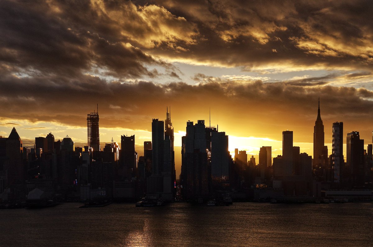 GaryHershorn's tweet photo. Storm clouds clear out of midtown Manhattan as the sun rises in New York City, Wednesday morning #nyc #newyork #NewYorkCity #sunrise https://t.co/1KcAWpeOlz
