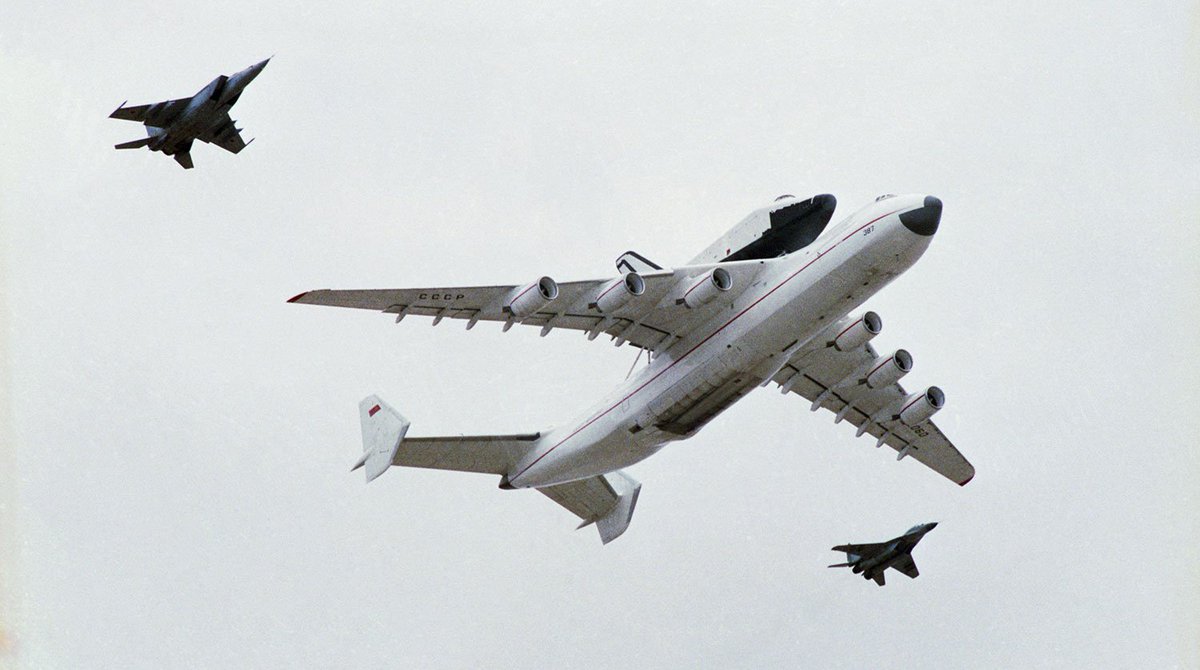 The mighty Antonov An-225 Mriya carrying the Buran orbiter and escorted by a MiG-25/31 and MiG-29? (please correct me).

A ridiculously view this must have been in real life. Unfortunately both Mriya and Buran have been destroyed since.