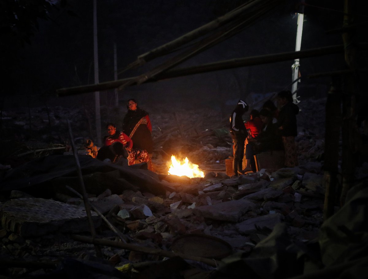 WasimSarvar's tweet photo. #Homeless people sit around a #Bonfire to #warm themselves on a #coldwinternight at #Mathuraroad #Nizamuddindemolishedarea, the roof over their heads #demolished amid the biting cold of December #antiencroachmentdrives over the last few weeks in new Delhi on Wed, Jan 10, 2024. https://t.co/yCcTG61JQz