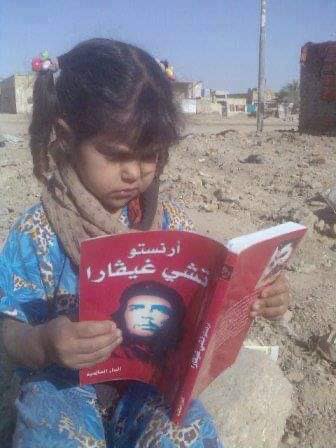 TheIntlMagz's tweet photo. An old picture of a little Palestinian kid reading about Che Guevara. https://t.co/D41yd0IgYS