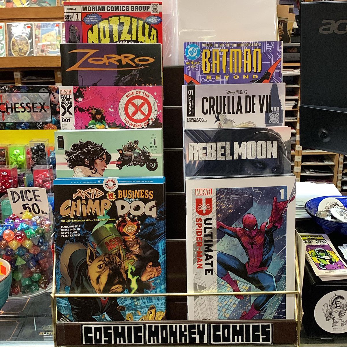 Here’s our featured rack! #acidchimpvsbusinessdog #ultimatespiderman #adventuremanghostlights #rebelmoon #riseofthepowersofx #disneyvillainscruelladevil #zorromanofthedead #batmanbeyond #notzillabeermakeshimgrow #cosmicmonkeycomics #ncbd #newcomics