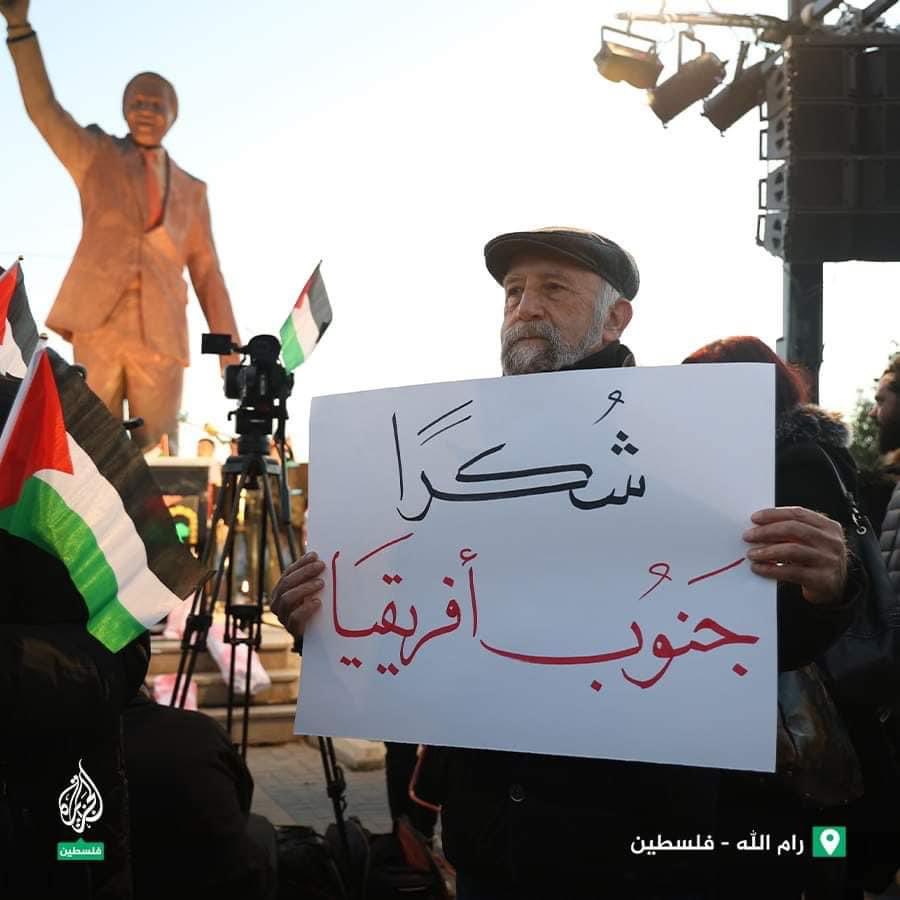 ZeinaAshrawi's tweet photo. My father earlier today in Ramallah, Palestine holding a sign that reads “Thank You South Africa” in Arabic, standing by Nelson Mandela monument. 

South Africa brought a case to the ICJ against Israel &amp; its ongoing genocide in the Gaza Strip. Case in court tomorrow
#ceasefireNow https://t.co/lFExwRW6Td