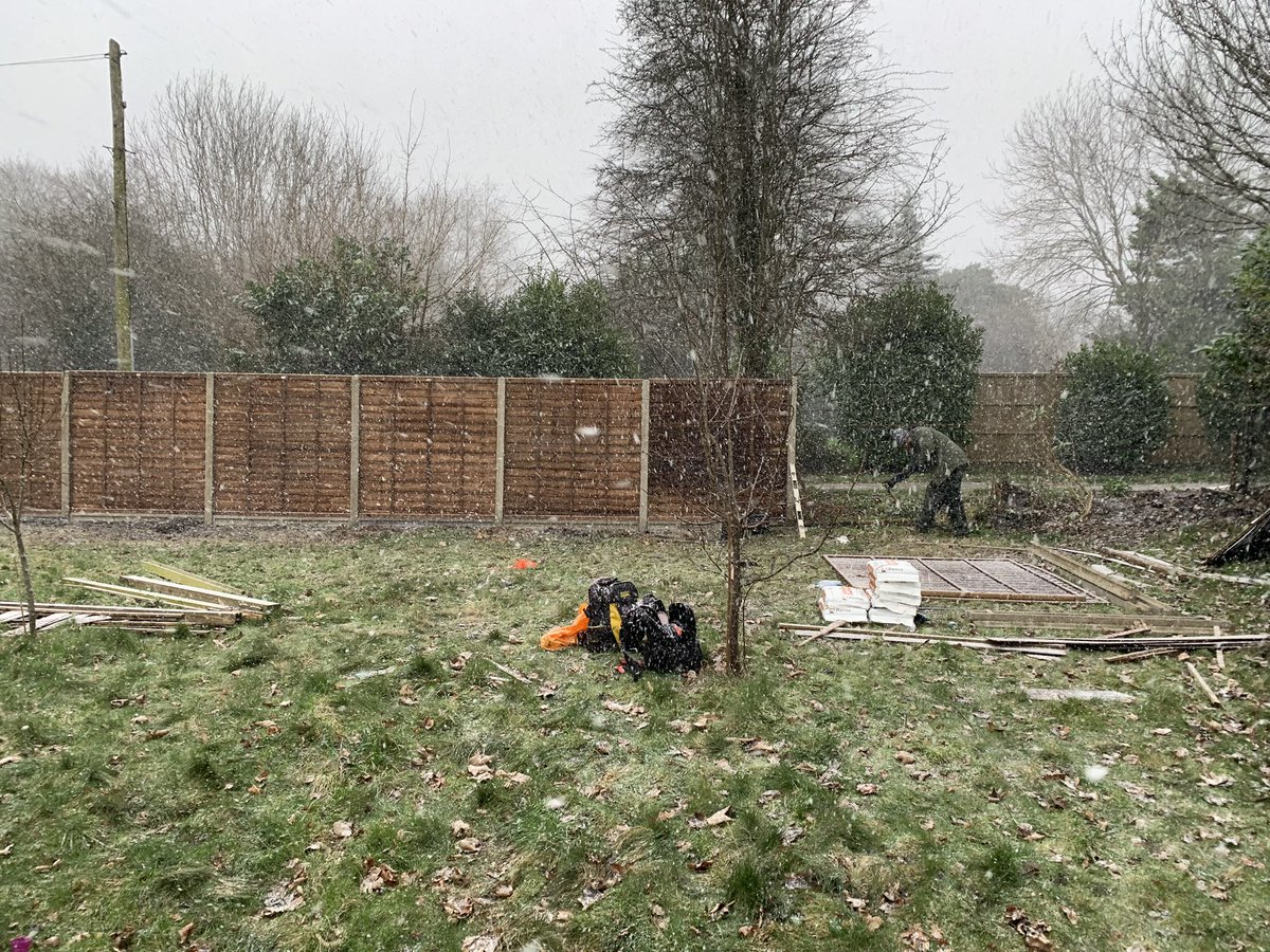 NakedGardener75's tweet photo. Replacing a very broken fence with some lovely new panels. Challenging in a blizzard but at least we had the fire going 😄 #GardeningTwitter #GardeningX #Fencerepairs #WINTER https://t.co/nOfsdsf2V0
