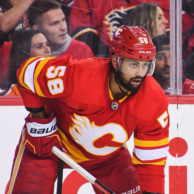 Oliver Kylington in a red Flames jersey