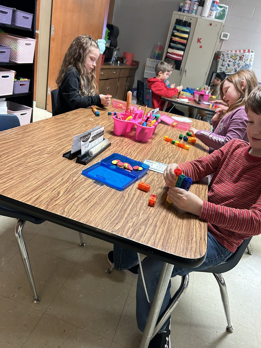Mathematicians are using connecting cubes to find the missing addend!