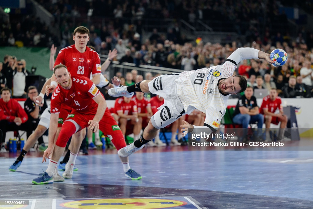 Jannik Kohlbacher (R) of Germany is tackled by Lenny Rubin (L) of Switzerland during the Men's #ehfeuro2024 preliminary round match between 🇩🇪 and 🇨🇭 at Merkur Spiel-Arena in Duesseldorf, Germany. I January 10, 2024 I 📷: Markus Gilliar/ @gessportfoto #GettySport #heretoplay