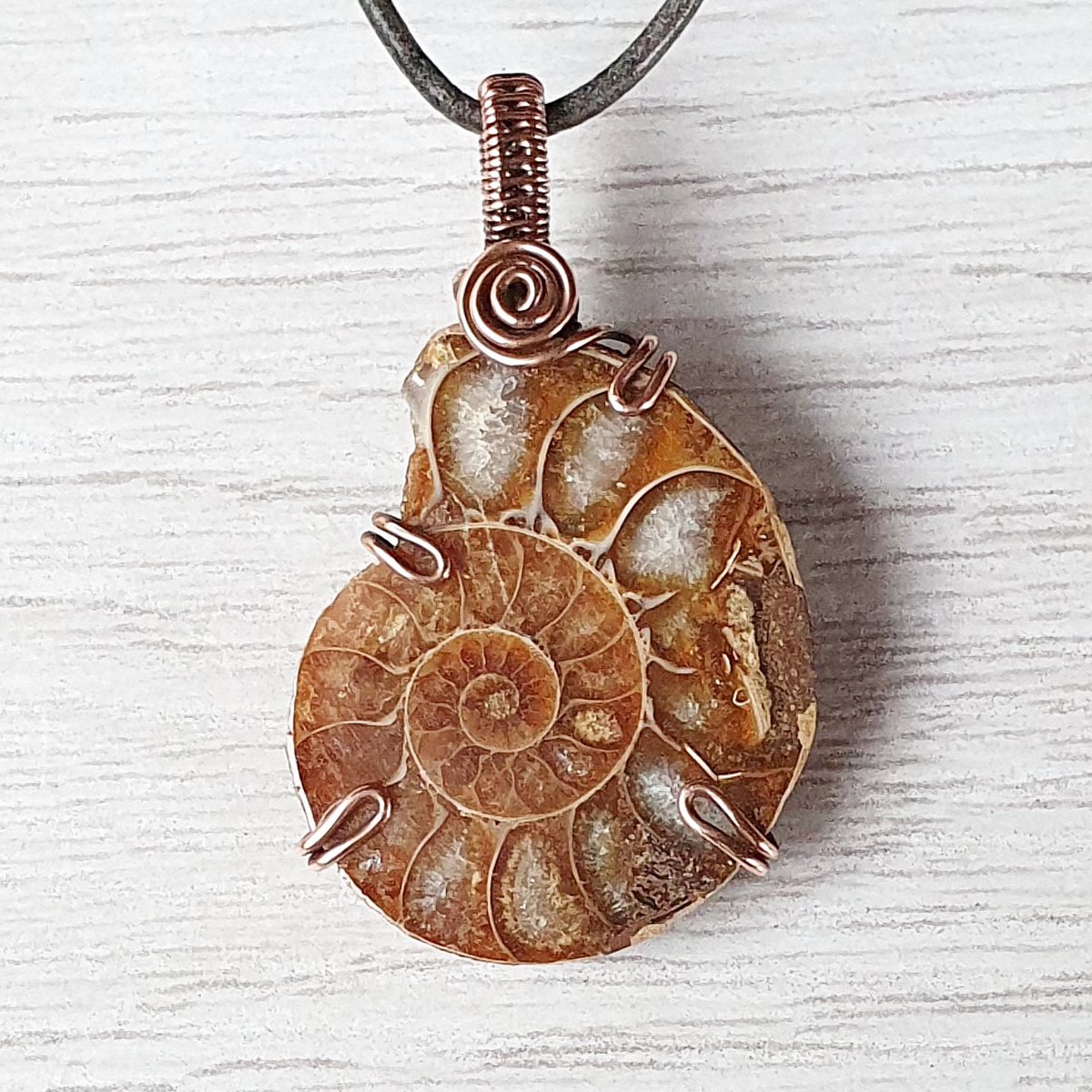 OrphicCrystal's tweet photo. This #handmade #pendant features ancient #ammonite wrapped in raw copper. I love how it holds so much history &amp; like to think that it must have witnessed so much over the centuries. Imagine all the #Wisdom it must contain! #smallbiz #crystaljewelry #handmadejewelry #giftideas https://t.co/0ruYwdGOKO