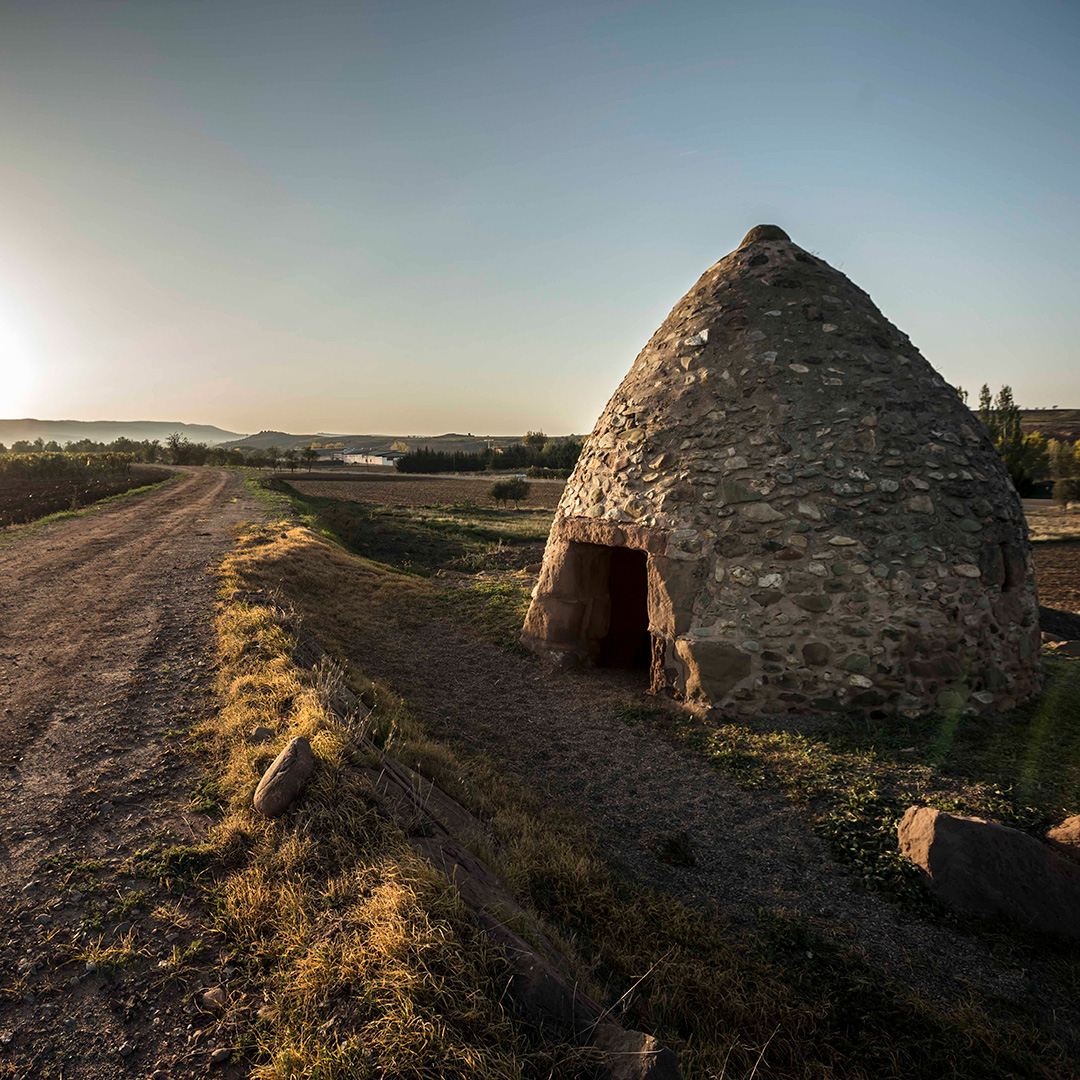 If you visit Rioja, you may spot these little structures called “chozos.” A chozo, which is Spanish for “hut,” is a small shelter that grape growers can sit in to stay protected from unwelcoming weather.