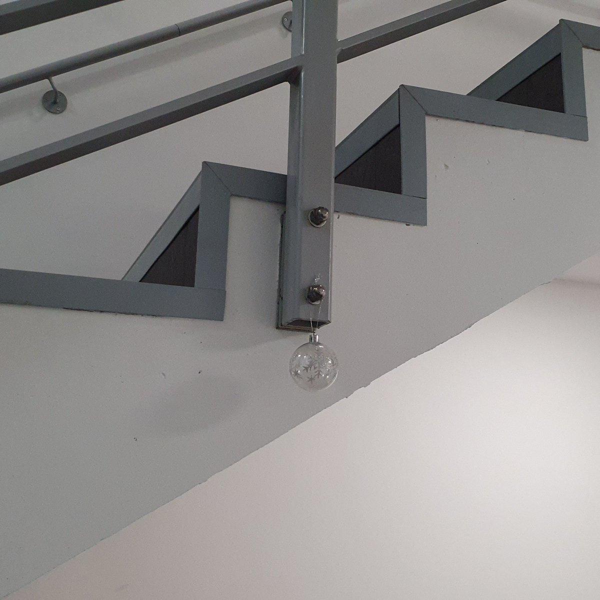 Although @KingstonUni have taken down their #Xmas decorations, a single escapee bauble can still be spotted in a back staircase... but how did it get there and why? #themysteryofthelonebauble