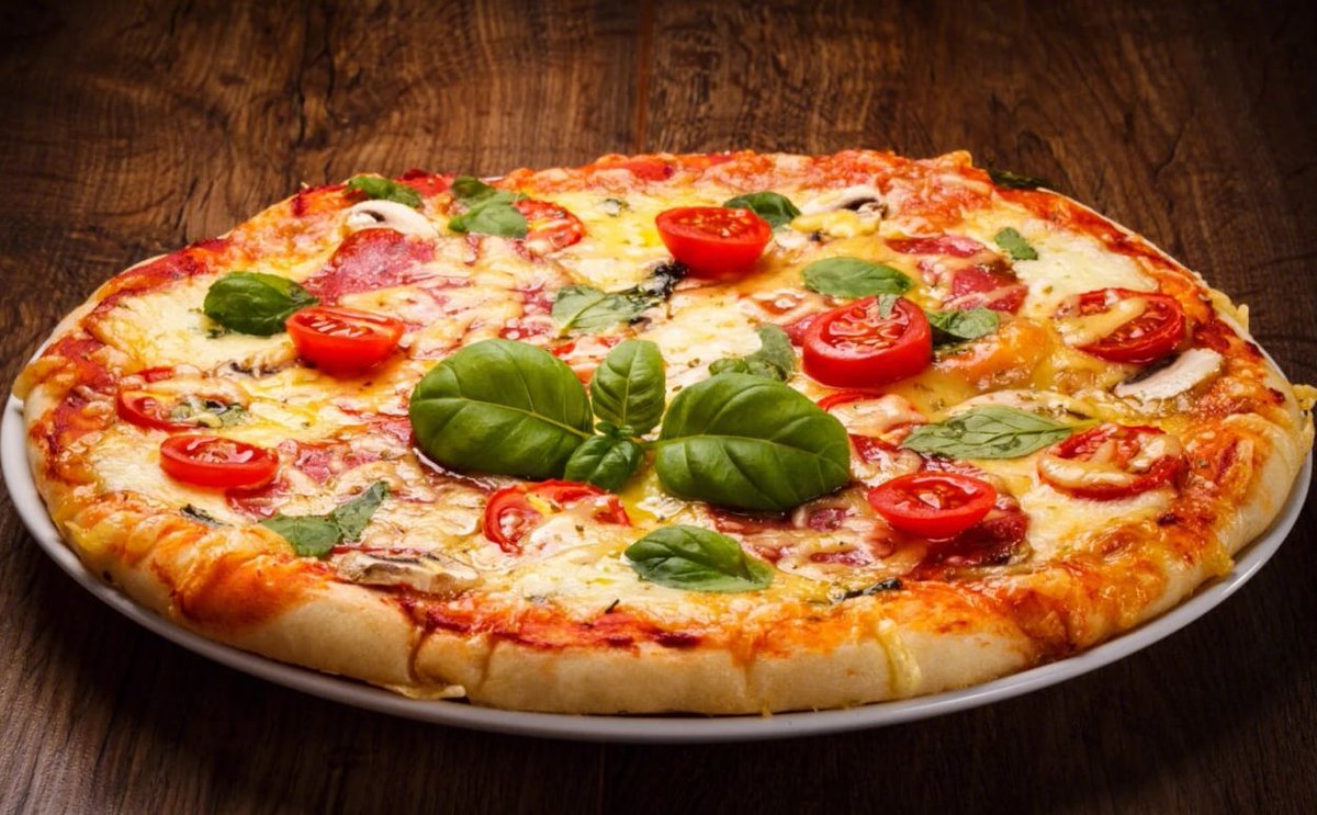 ""Indulging in a slice of happiness tonight with this mouthwatering pizza! Who's up for a virtual pizza party? 🍕🎉