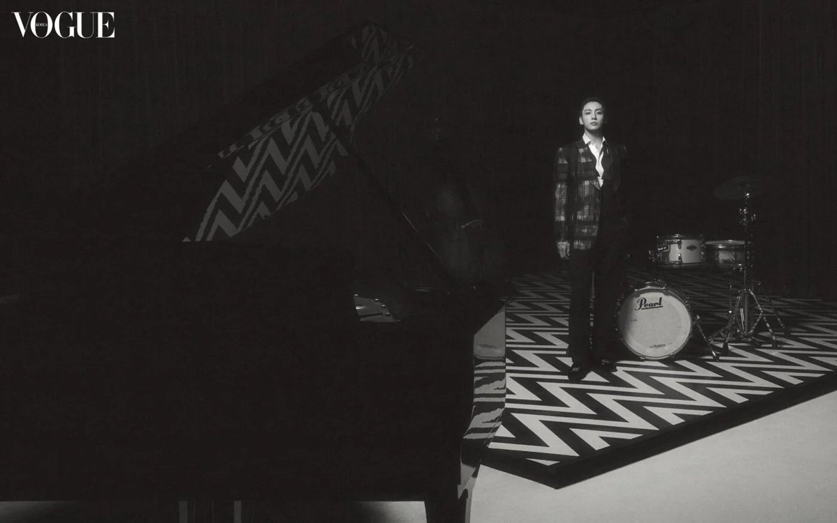 A grand piano, drums, saxophone, whisky and velveted curtains … Jung Kook stands masculine, yet gentle in the middle of a 1920s Jazz Bar. Tuxedo jacket, vest, pants, shirt, bowtie and loafer, Ralph Lauren Purple Label.