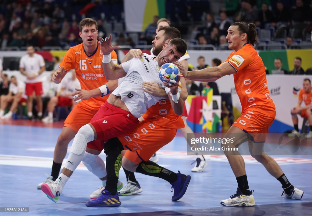 Erekle Arsenashvili of Georgia is challenged by Tim Claessens and Iso Sluijters of The Netherlands during the Men's #ehfeuro2024 preliminary round match at SAP Arena in Mannheim, Germany. |January 11, 2024|📷: @AlexGrimmPix #GettySport #heretoplay