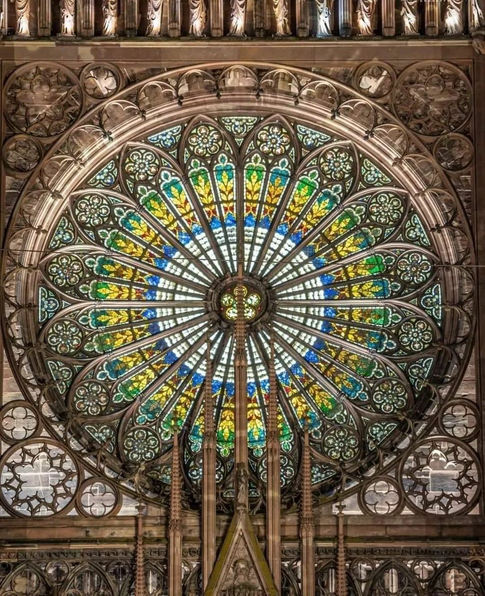 archeohistories's tweet photo. The rose window of Strasbourg Cathedral; France, is without doubt one of the most beautiful achievements of the building. Designed and built by Master Erwin, one of the builders of Notre Dame de Strasbourg, it is considered the most beautiful rose of all the Gothic cathedrals of the 13th Century CE. Symbolically, the great rose of the cathedral is the time of God. The circle evokes the flow of time in its movement, which is recalled by the wheel. Inexorably, time flows and begins again. 

Erwin's Rose, the rose window of Strasbourg Cathedral, symbolises the cosmos and represents the creator at its center. The concrete implementation of Master Erwin's designs was entrusted not to a master glassmaker, but to a master goldsmith whose workshop was located at the back of a courtyard in the Rue des Orfèvres, a stone's throw from the Cathedral. It is often said that a mixture of diamond dust and precious stones was added by the goldsmith to the preparation of the glass.

#archaeohistories