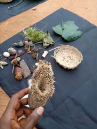 VoiceOfTheEast's tweet photo. Have you heard about Iyi uwa?

An lyi-uwa is an object that binds the spirit of a dead child (known as ogbanje) to the world, causing it to return and be born again to the same mother.
Many objects can serve the purpose of iyi - uwa, including stones, dolls, hair or pieces of the dead child's clothes, omens, or offerings. 

The iyi-uwa must be found and destroyed in order for the ogbanje to rest and stop haunting the mother.
To find the object, a dibia questions the spirit and performs rituals to force it to reveal where the iyi-uwa is located.