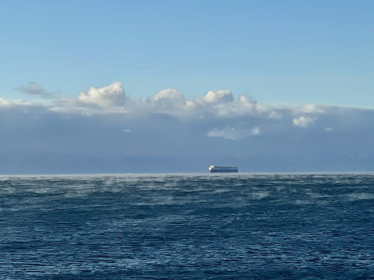 ianhinkle's tweet photo. Sea smoke: fog blowing across the surface. Strait of Juan de Fuca, near Victoria. 
Water temp 6 ° C. 
Air temp: about -12°C. https://t.co/My3tCBmcSO