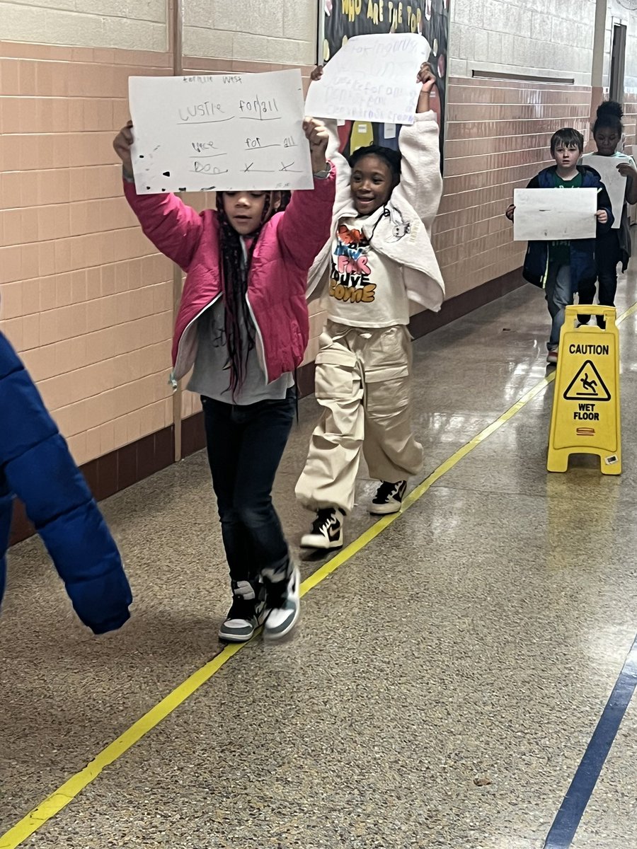 153_es's tweet photo. Oceanair second graders led a peaceful protest for change through the halls as part of their integrated history curriculum. @NPSchools_VA @KatrinaRountree @kolem_K https://t.co/klG71wfw8m