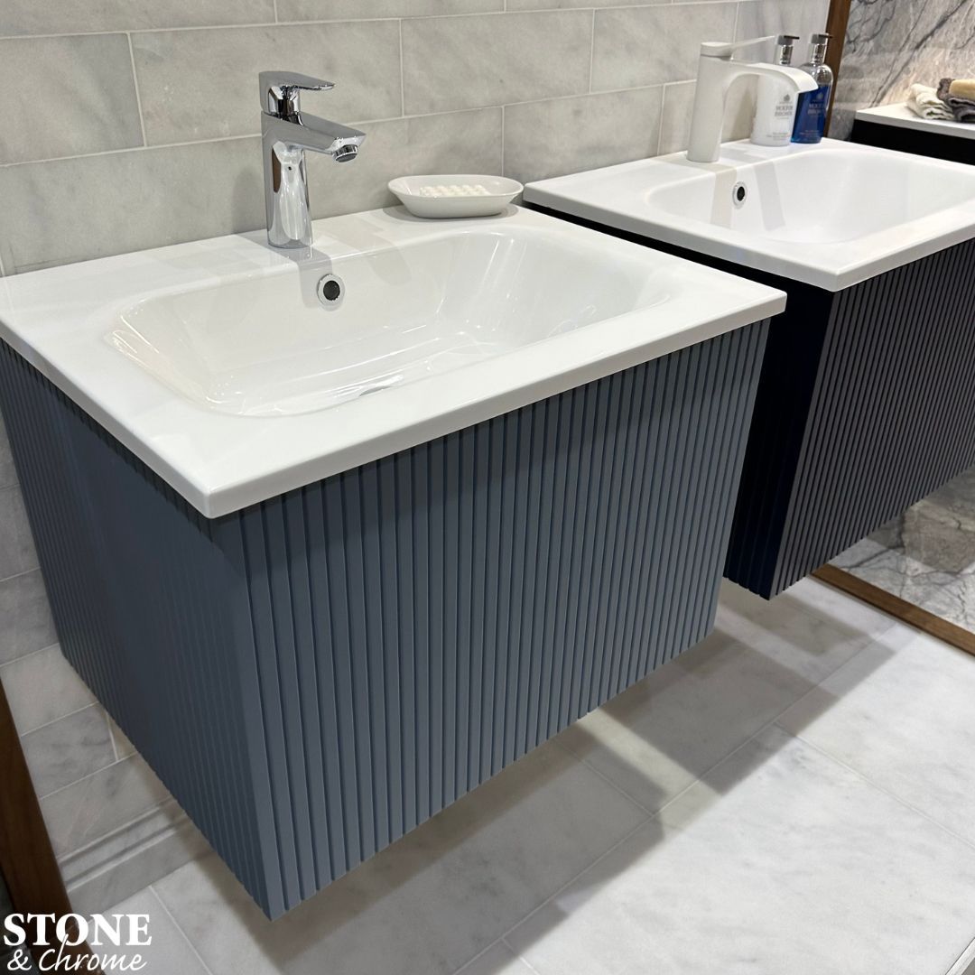 Add some character with a fluted vanity unit 💙 - Calypso Minori basin unit in Aegean Blue and Admiral Blue. Also available in Opal White and Feather Grey. - hansgrohe basin mixers in Chrome and Matt White. - Tiles by Ca' Pietra. --- 📞 01276 61000