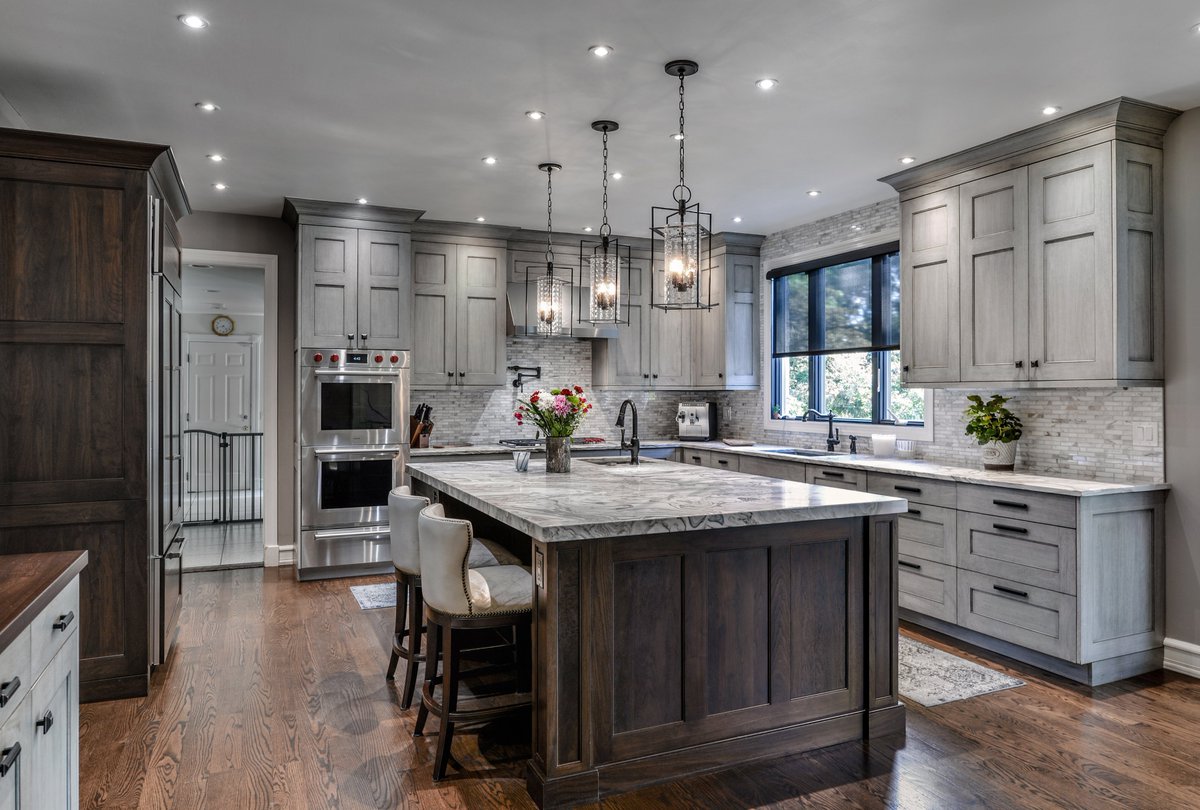 Beautiful custom #RuttCabinetry #kitchen  designed and installed in #GlenHead, NY. Wonderful shades of gray complement a rich walnut #kitchenisland. #kitchendesign by Elite Kitchen & Bath, Manhasset, NY