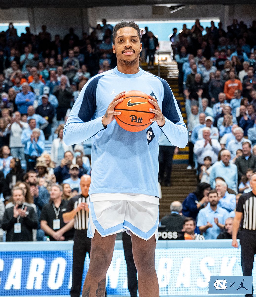 UNC_Basketball's tweet photo. Special moment here in the Dean Dome 🙌

Phil Ford presents Armando Bacot the game ball from his 2,000th point scored at Pitt. https://t.co/PLBx3X4p4g