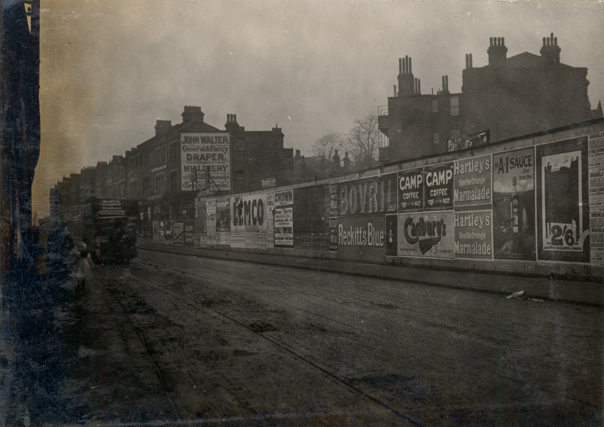 Milkwood Road #HerneHill, December 1905. Can be dated by the hoarding showing the popular play The Scarlet Pimpernel at the Crown Theatre Peckham. The fire station (now Sainsbury’s Local) was built the following year.