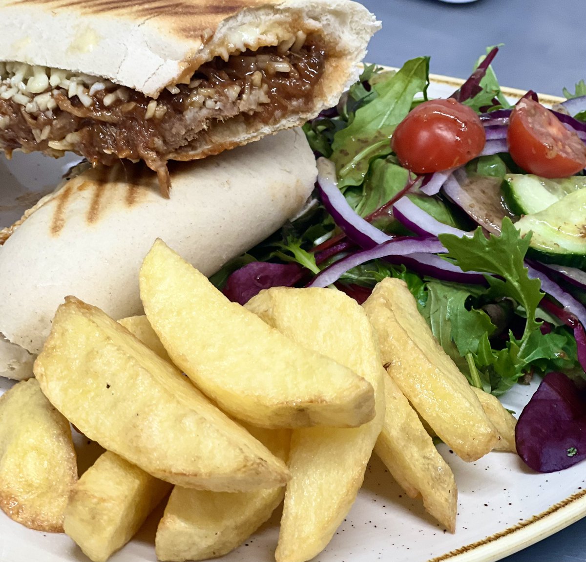 New on our menu - slow roasted pulled pork in barbecue sauce &amp; cheddar cheese panini. 
Served with hand cut chips &amp; a side salad drizzled in homemade honey mustard dressing. 

#slowroasted 
#pulledpork
#cheddarcheese 
#babequesauce 
#homemadechips 
#sedbergh