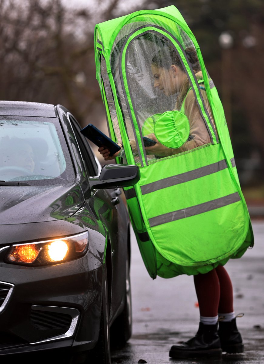 Abigail Hockett wears the latest in rain fashion as she takes orders at Dutch Brothers Coffee in Santa Rosa, Saturday. <a href="/NorthBayNews/">The Press Democrat</a> #CAwx