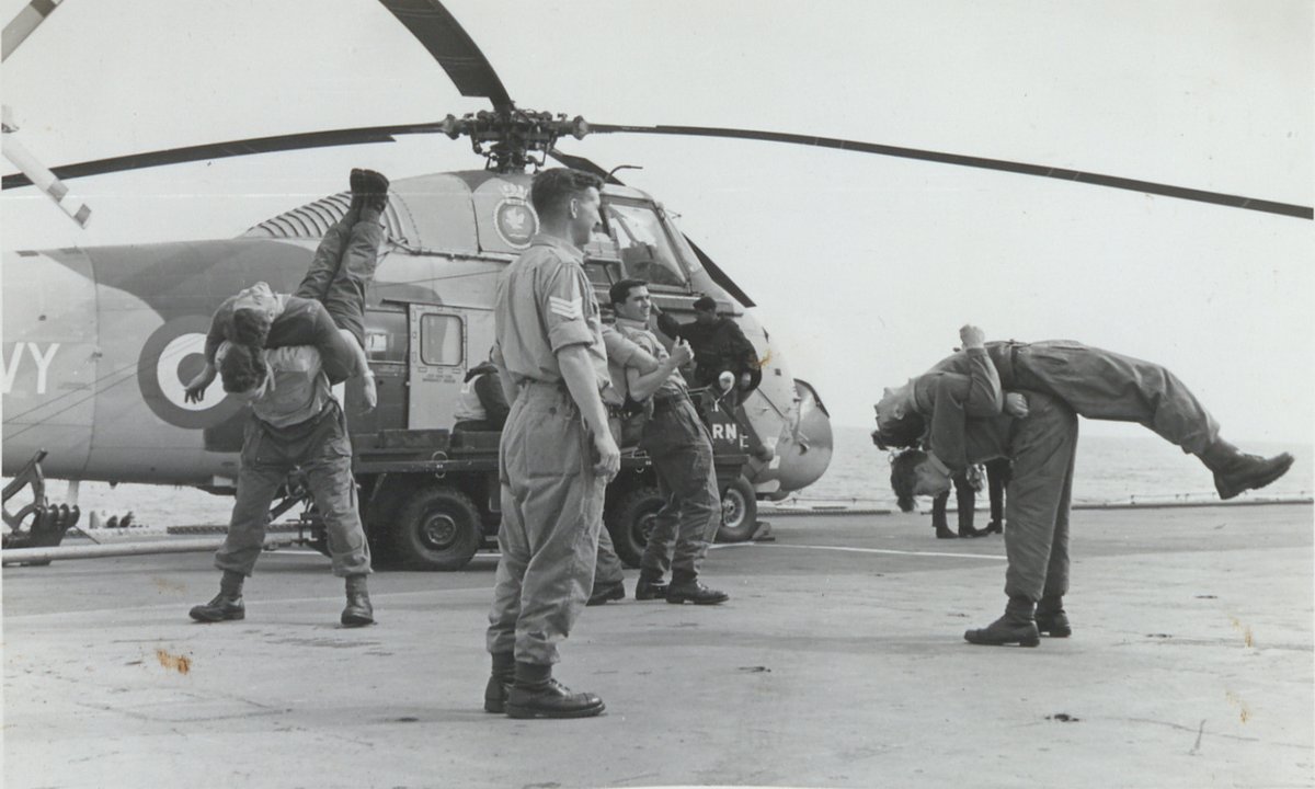 Physical exercise on the flight deck of the commando carrier HMS Albion with a Westland Wessex helicopter in the background, 25 May 1967. The photograph is captioned with the date: '25th May 1967'. The Marines are from 41 Commando Royal Marines. ON: RMM 1978/98c259