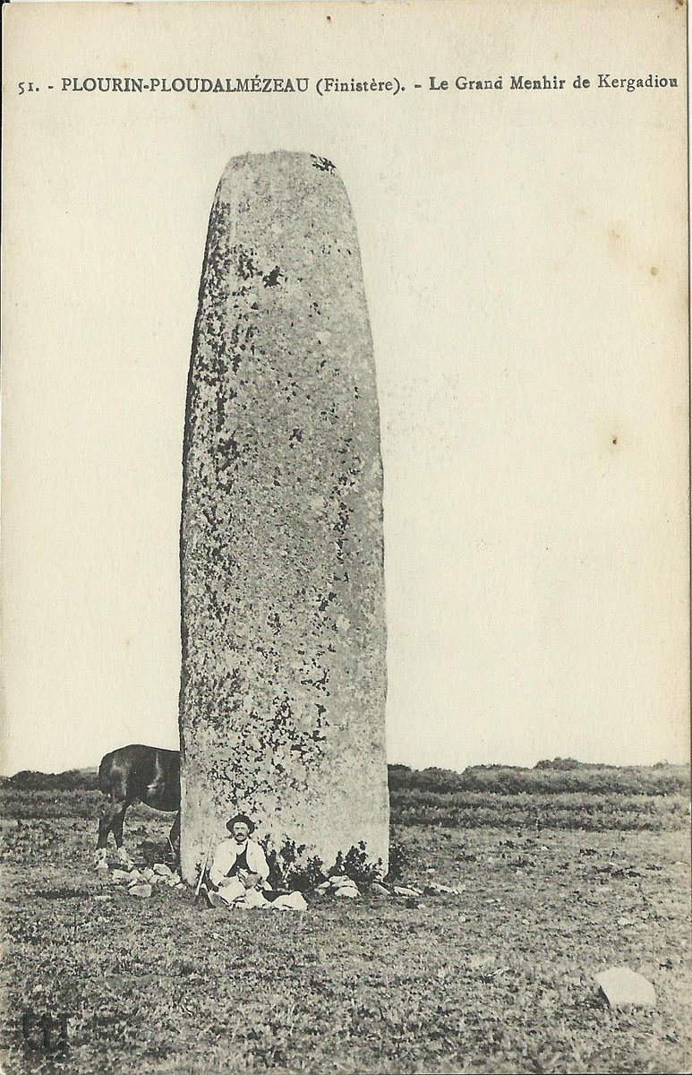 The menhir of Kergadiou in Plourin (Finistère) is among the top ten in Brittany and stands 8.5m above the ground. It has been deliberately shaped and smoothed over most of its surface. Nearby is another even bigger fallen one. Card by F.T., Brest c.1908. #StandingStoneSunday.
