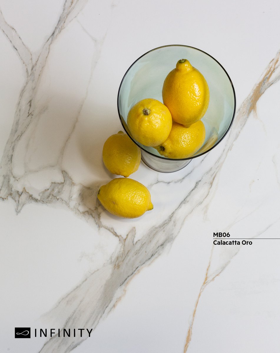 InterslabZA's tweet image. The classic veining and marble look with grey and gold veins atop an off-white background is what makes #InfinitySurfaces #CalacattaOro unique. Add in a pop of colour, like a bowl of lemons, to add a sense of freshness. bit.ly/CalacattaOro #interslab #interiordesign
