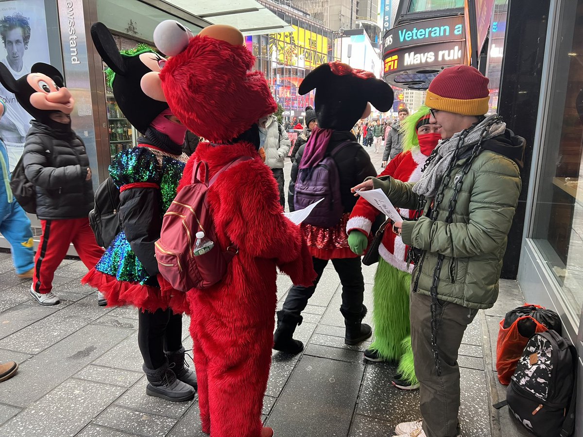 ZhouFengSuo's tweet image. 王涵在曼哈顿时代广场绝食纪念铁链女被发现两周年。在熙攘人群中一个个的发送传单，人流中孤单而平常，但是
他今天已经送出一百多张。他的精神感动了旁边的店主，他破例让王涵把传单贴到售货亭。他的脖子上也缠绕了铁链。寒冷的冬天，还会下雨，而他要坚持一周。