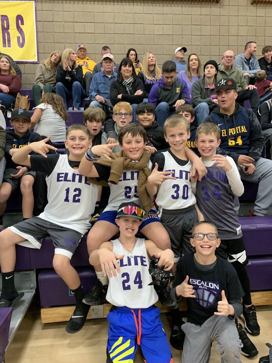 Youth night at EHS. All kids wearing the basketball jerseys of their local teams got in free, these players settled in by the Cougar bench.