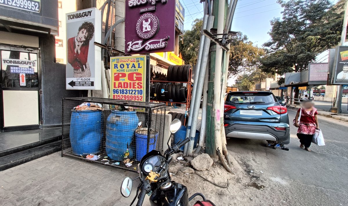 debanshuk's tweet photo. Mahadevapura ORR, Footpath is completely blocked by a cement-wall, garbage bins, signs and tyre-stands. Mechanic shop also services cars on the road. No action on complaints raised on https://t.co/HvyoV8HSOQ since June 2023 (No: 20396804 and 20357987). @BbmpEast @MALimbavali https://t.co/Dpze91ltBO
