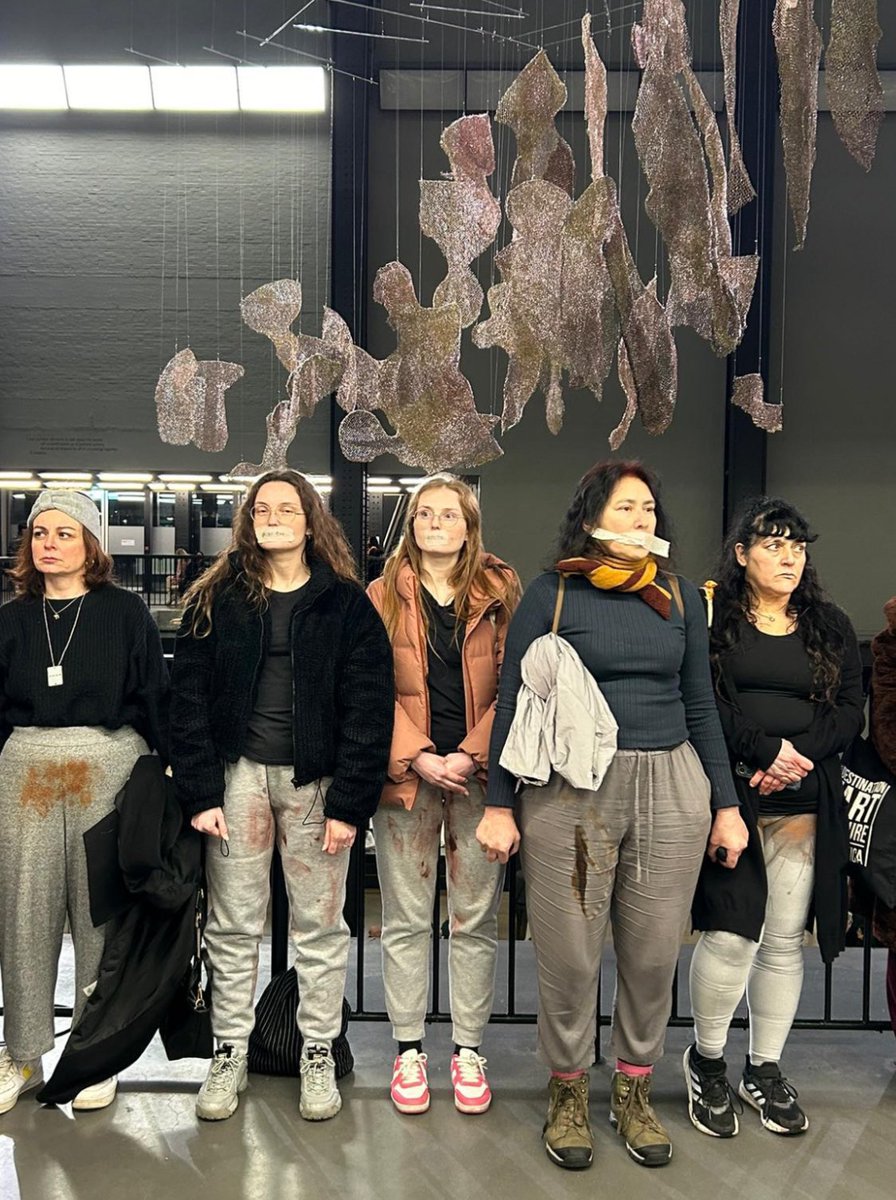 At the Tate Modern last night, a group of extraordinary women reminded a feminist crowd gathered about the rapes of Israeli women and the ongoing horror of the hostages. 
The tape across their mouths is a reminder of silence of the feminist organisations who have failed to speak