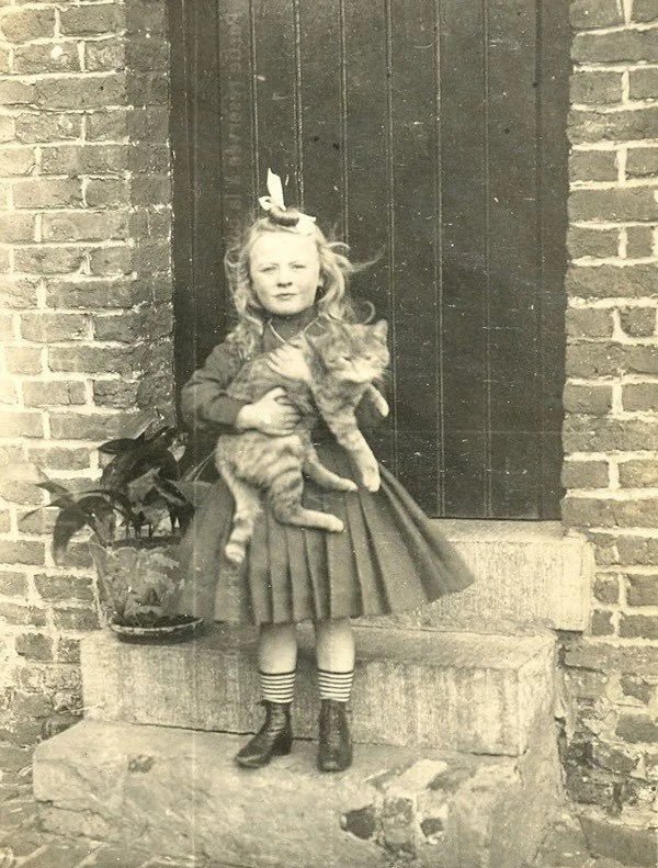 A girl with her cat, 1921

#Caturday
