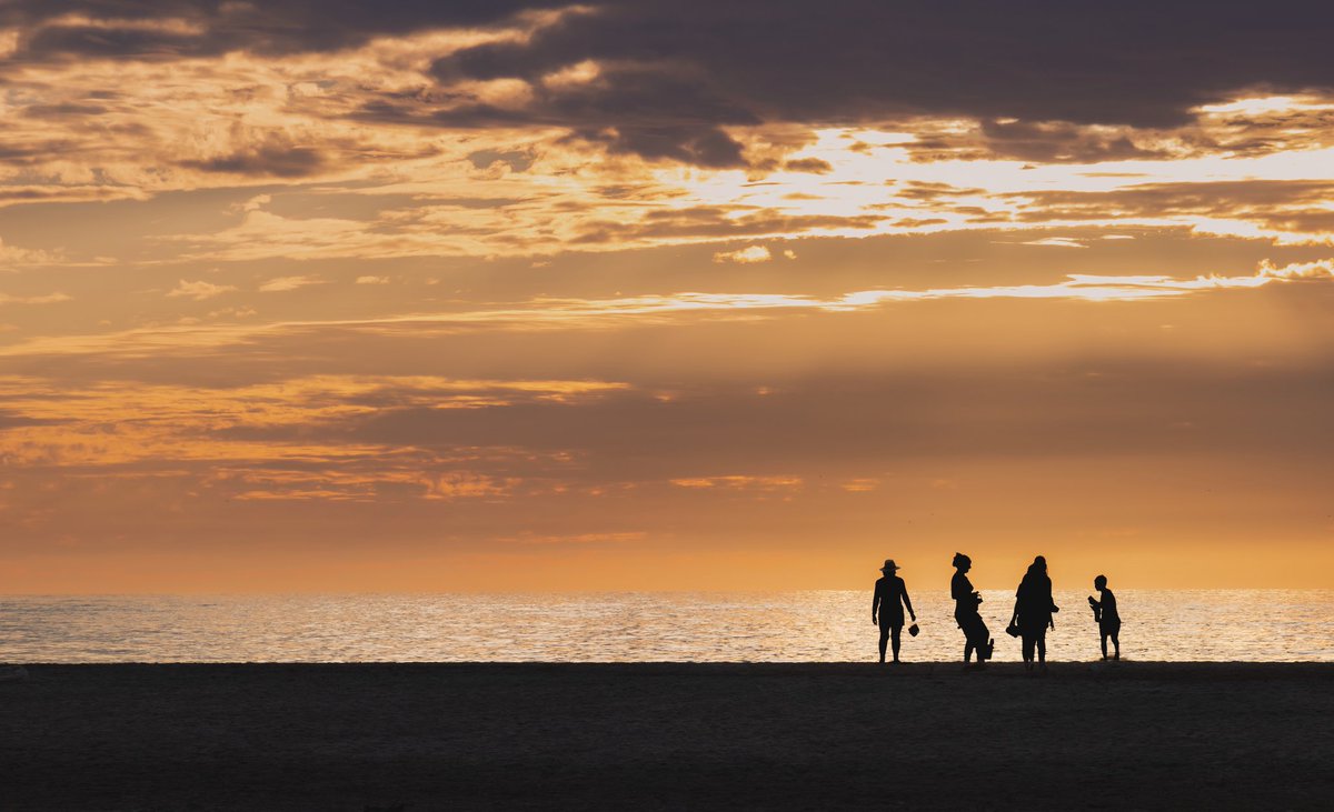 QT Silhouettes of family beach time.