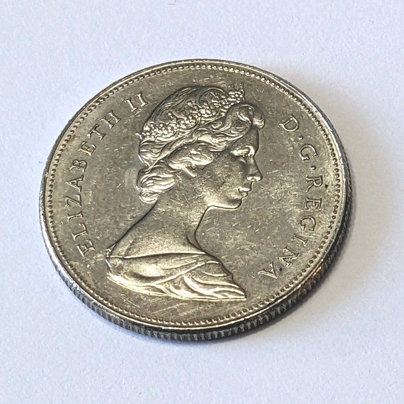 Explore this antique Canadian fifty-cent piece from 1968, graced with Queen Elizabeth II's imprint. It's up for grabs at COINeredShop's Etsy outlet. 🇨🇦🪙 #VintageCurrency #CoinHobby buff.ly/4bethzH