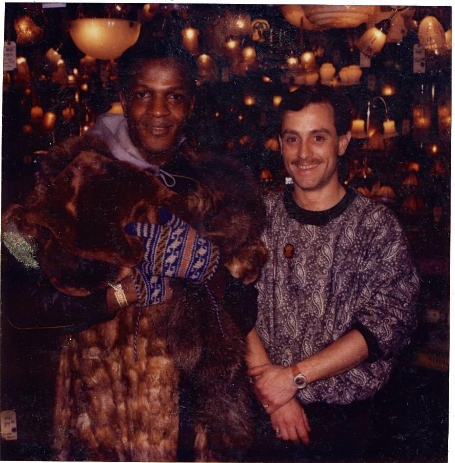 Rare photo of Marsha P. Johnson, the iconic black trans woman, & leader of the Stonewall uprising, captured at an event wearing a faux fur coat and mittens. She exudes stunning beauty in this image. The identity of the person beside her remains unknown. Credit to 📸 date unknown