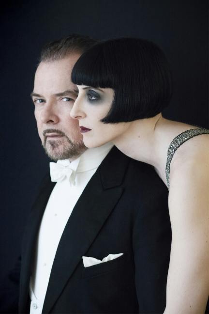 type___e's tweet image. these two married Egyptology professors who appear like this on the dust jacket of their co-authored book are not whodunit characters but flesh and blood humans existing in the year 2024