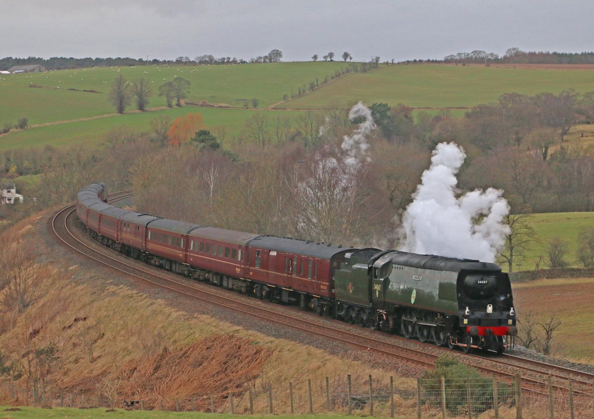 On a poor day weather wise “Battle of Britain” 34067 Tangmere climbs Shap at Greenholme and at Armathwaite Curve on the southbound run with the first Cumbrian Mountain Express of the year on Saturday 27/01/24. @railwaytouring @westcoastrail @RailwayMagazine