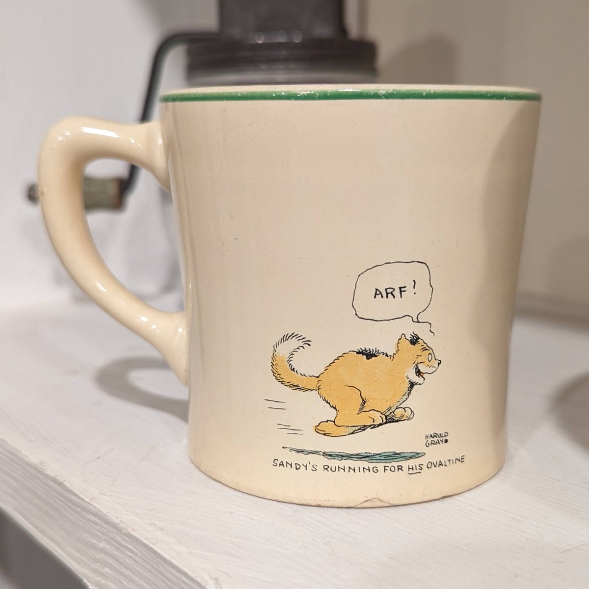 In the 1930s, Ovaltine sponsored the Little Orphan Annie radio show. As part of this advertising partnership, children could mail in the paper seals from Ovaltine cans and receive a mug like this one.