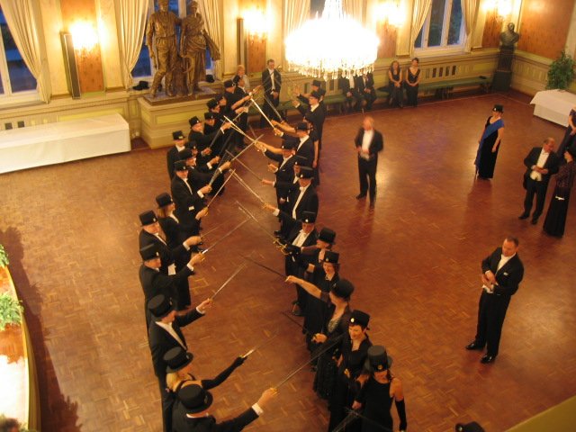 This is your periodic reminder that you should have completed a PhD in Finland. 

There the graduation regalia for PhDs includes a top hat and a sword.