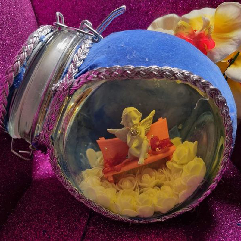 This pretty light-up glass jar by E &amp; M Bottle Arts and Crafts features an angel sitting on a pink seat on a cloud of white roses and would be ideal as a memorial keepsake

Find this in their #ConsciousCrafties shop here: consciouscrafties.com/handmade-gifts…

#SBS #SBSWinners #HandmadeGifts