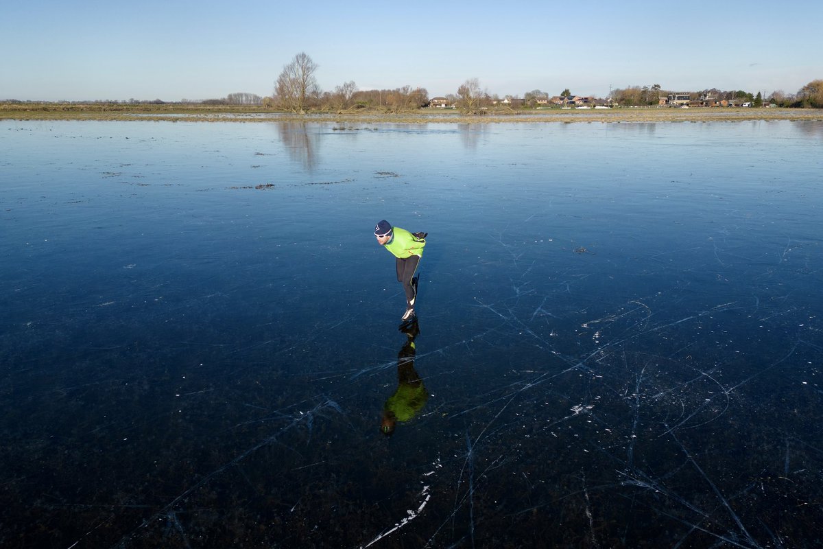 People skate on a frozen flooded field in Upware, Cambridgeshire. The Cambridgeshire Fens were the birthplace of British speed skating and require four nights of temperatures reaching -4 or below and no thawing during the days in between to make the ice strong enough to skate on