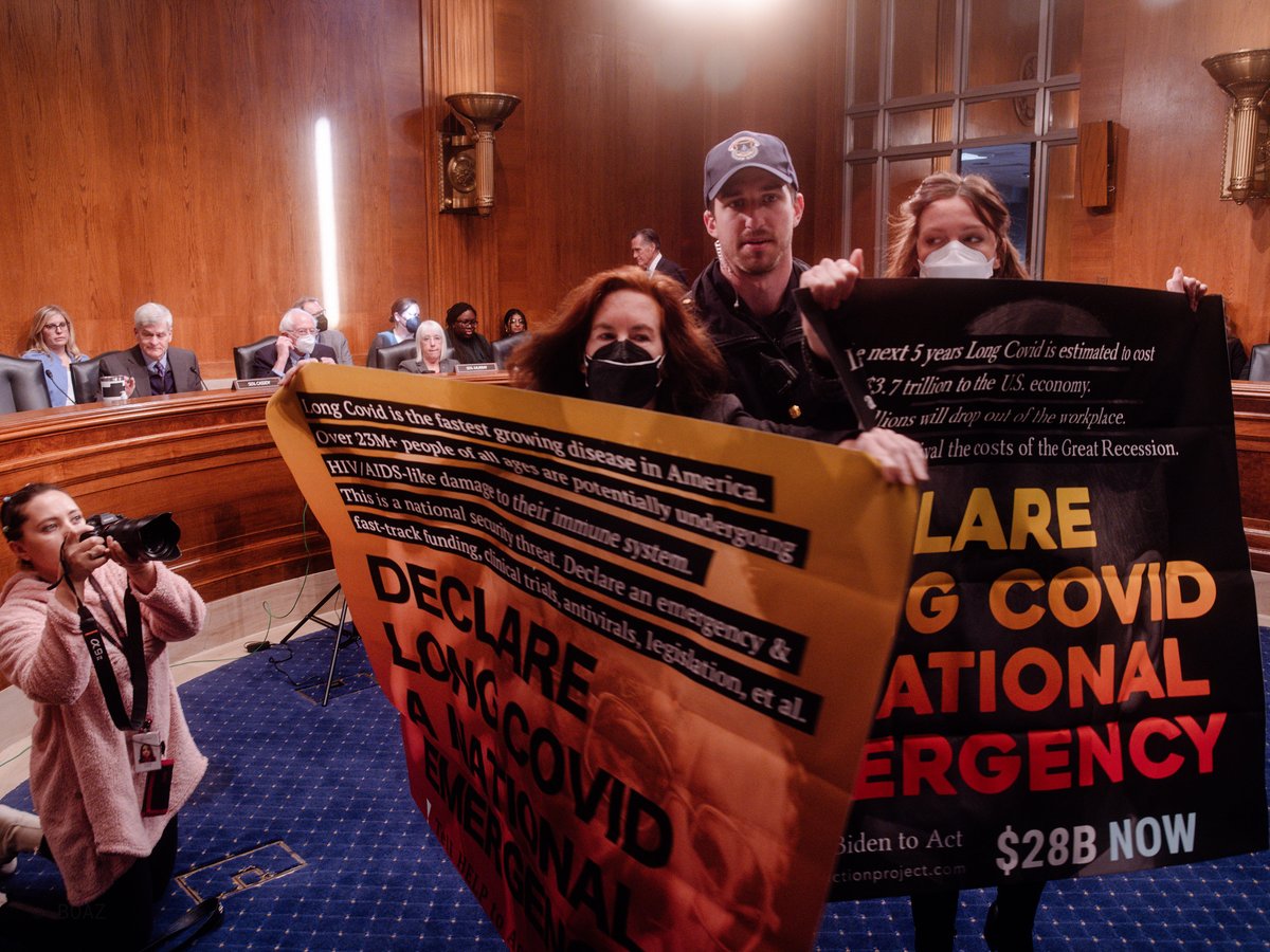 PublicHerald's tweet photo. Today Public Herald attended the HELP Senate Hearing on #LongCovid and captured two activists going by the names Stephanie Conan (⬛️sign) & Linda Roberts (🟧sign) who held the first direct action for #LongCovid in D.C. disrupting Senators at the committee, chanting "LCAP Fights Back, Declare Long Covid a National Emergency, Antivirals Now, Declare Long Covid a National Emergency, $28 Billion Now, Declare Long Covid a National Emergency, Moonshot Kills, LCAP Fights Back, Long Covid Aids, LCAP Fights Back, Long Covid Aids."
Linda Roberts and Stephanie Conan both have Long Covid.
Roberts and Conan performed the direct action with the organization LCAP who have led a Long Covid grassroots movement focused on government accountability and awareness for Long Covid. Both activists were escorted by security out of the HELP committee hearing and ejected from the building after accessing the well (center of the room) to drop two banners. Linda Roberts told Public Herald, "I felt compelled to act today because the government continues gatekeeping the patient community and to curate a story that minimizes Long Covid. Patients are developing AIDS-like immunodeficiency and succumbing to opportunistic infections and cancer. But these stories are not being told. The situation is urgent. We have no treatments and no seat at the table to shift the focus to one that will save lives. It's time to get loud to be heard. LCAP fights back."
After the action Stephanie Conan told Public Herald “I took direct action today to show those in power that we won't be silenced about Long Covid demands; if they're uncomfortable, we'll get louder."
© Joshua Boaz Pribanic for Public Herald (licensing available at https://t.co/FO3O87MfPl)
***A collection of photographs will be posted here & high res images on PH's flickr account
Conflict of interest note: Joshua Pribanic is the co-founder of Public Herald and also the founder of LCAP. Pribanic participated at the HELP hearing today as a journalist for Public Herald.
#LongCovid #DemandHELP #HELPLongCovid #LongCovidKids #pwLC