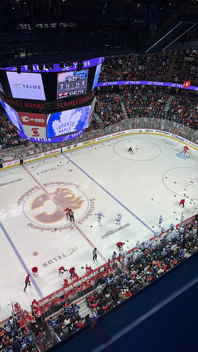 frank_seravalli's tweet image. Hats litter the ice (in Calgary!) for Auston Matthews’ fourth hat trick of the season.